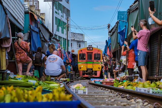 Amphawa Floating Market & Maeklong Railway Train Market Tour - Wat Bang Kung: banyan roots around Buddhas, and the dress code reality