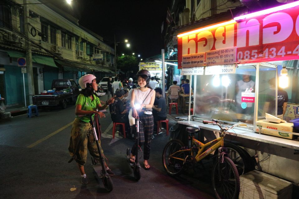 Bangkok: E-Scooter Night Tour with Local Street Food - Chao Phraya River crossing and riverside energy